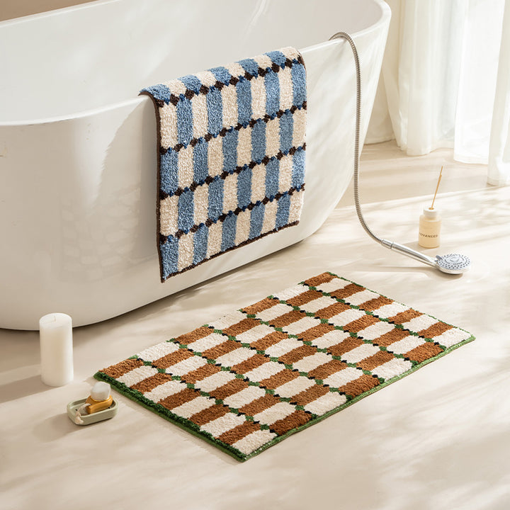 Hand-tufted bathroom mat with a velvety pile, non-slip latex backing, and geometric honeycomb check pattern Kalsten