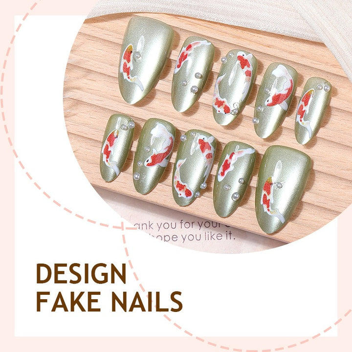 Artificial nail set with filigree koi fish designs and glitter accents Kalsten