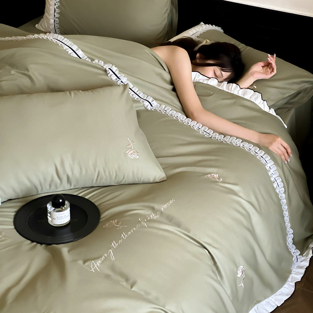 Cotton satin bed linen set with delicate rose embroidery, ruffled edge and contrasting reversible look