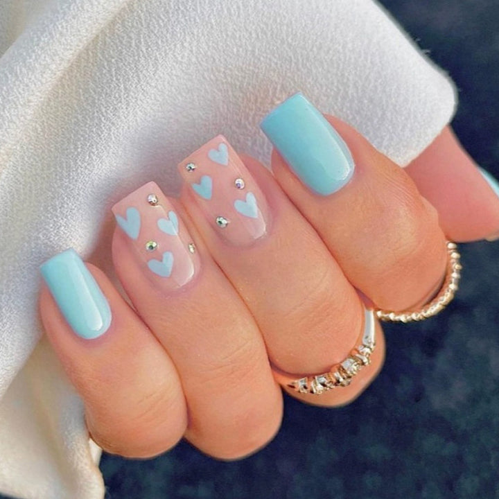 Nail art with heart designs and glitter accents Kalsten