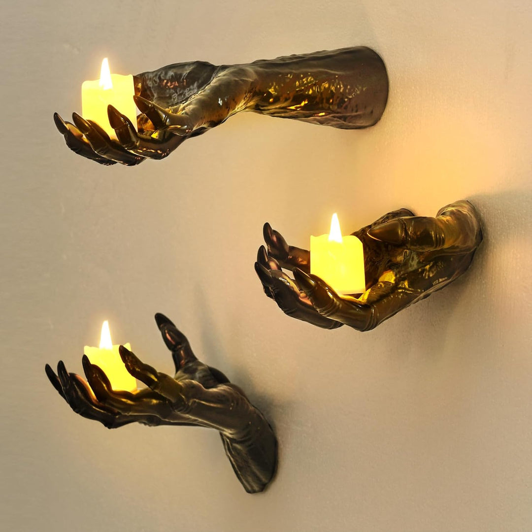 Wall candle holder in realistically shaped hand made of resin