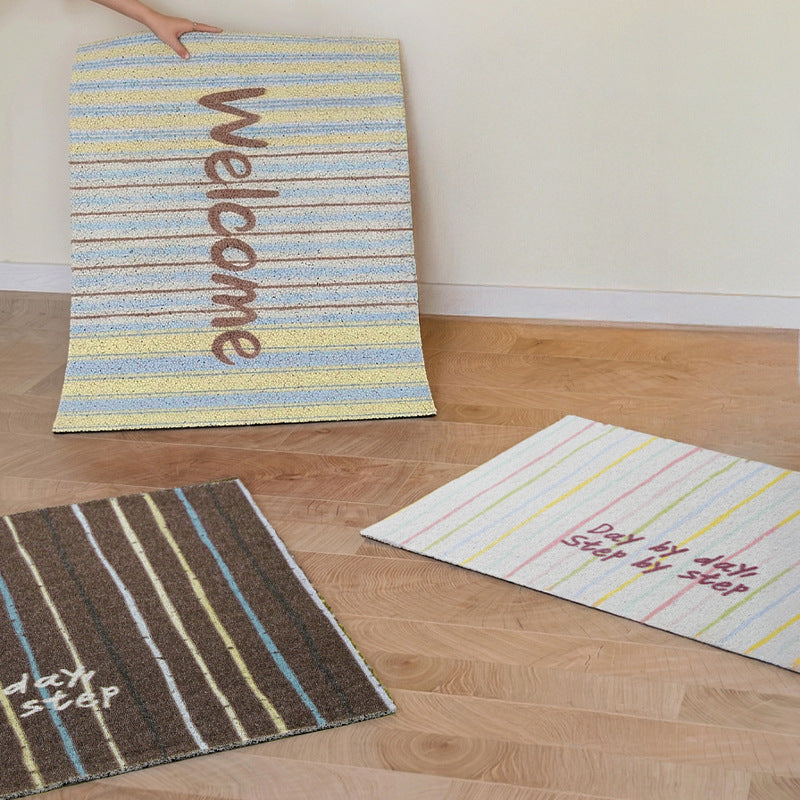 Woven door mat with welcome inscription, striped pattern and non-slip back