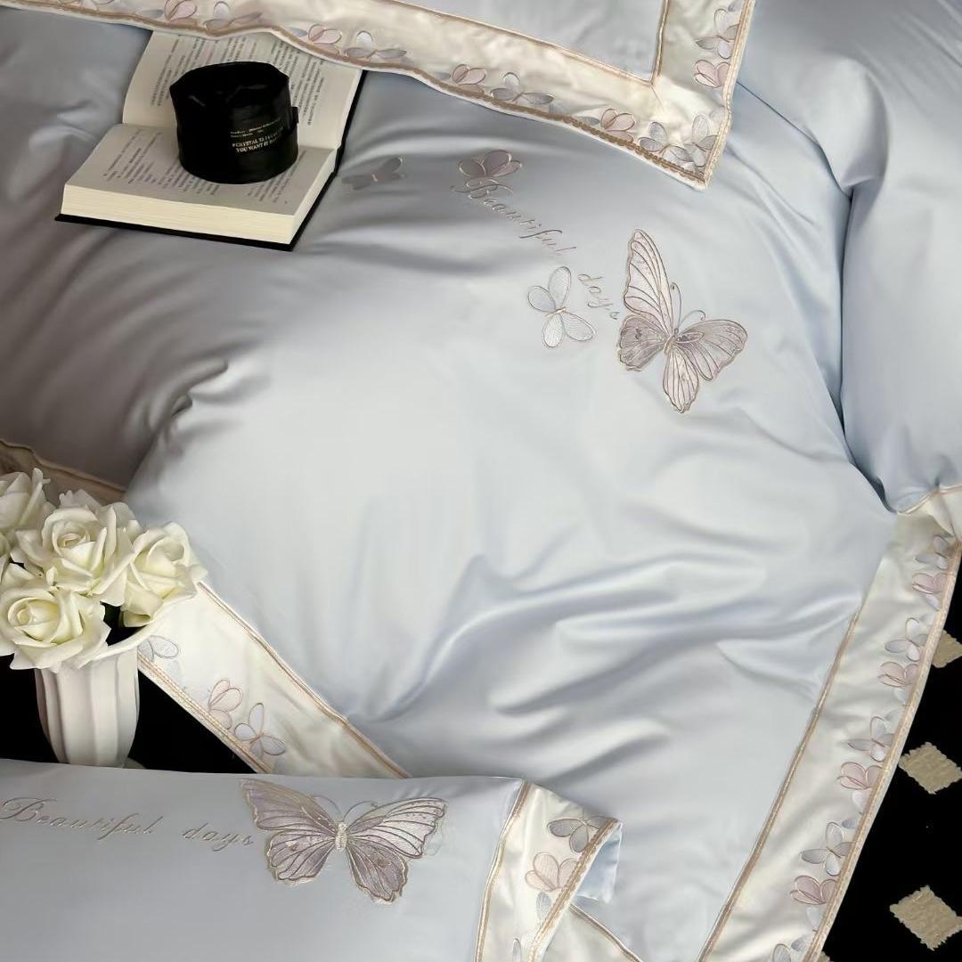 Satin bedding set with embroidered butterfly motif and silk-matte finish