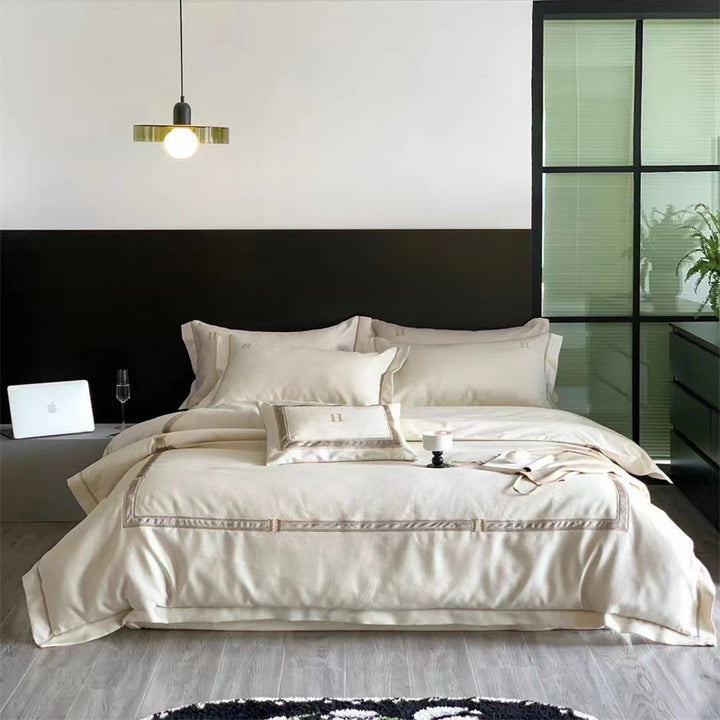 Exclusive satin bedding set with fine piping and monogram embroidery