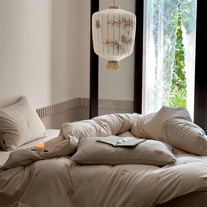Luxurious cotton satin bedding set with delicate floral embroidery and a silky-matte surface
