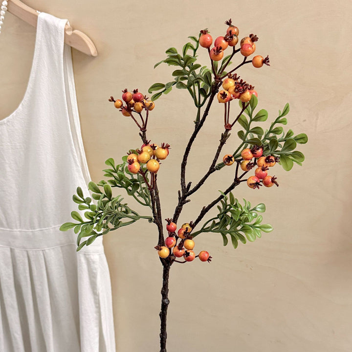 Artificial branch with glowing berries and green