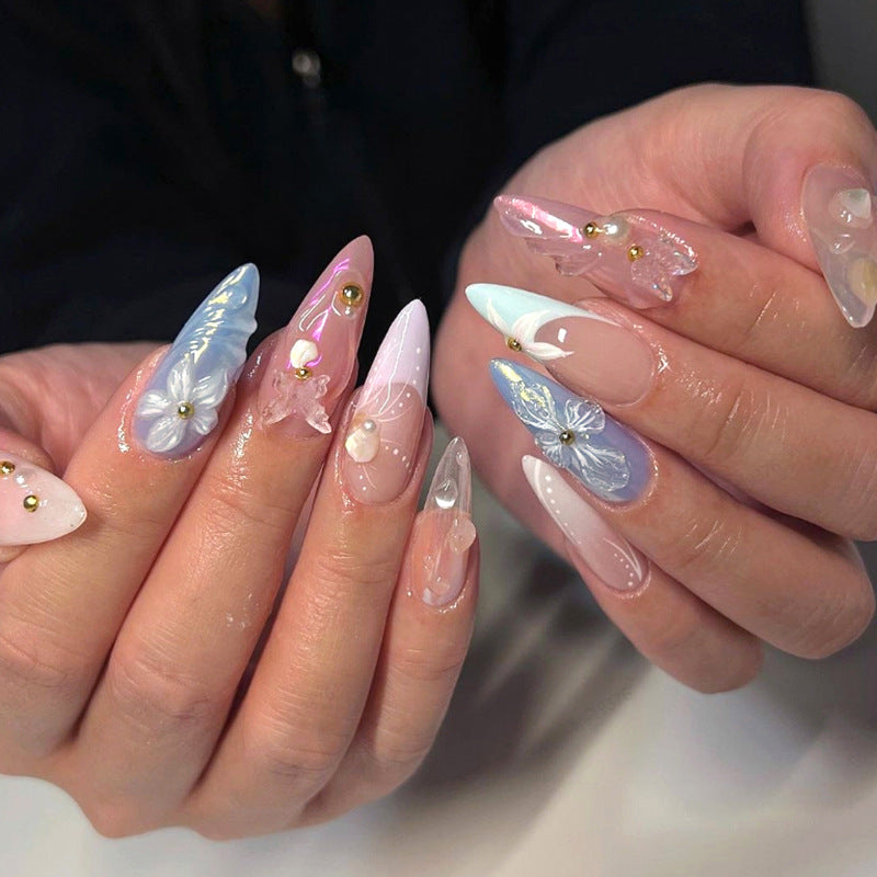 Artistic stiletto nails with delicate flower and glitter embellishments Kalsten