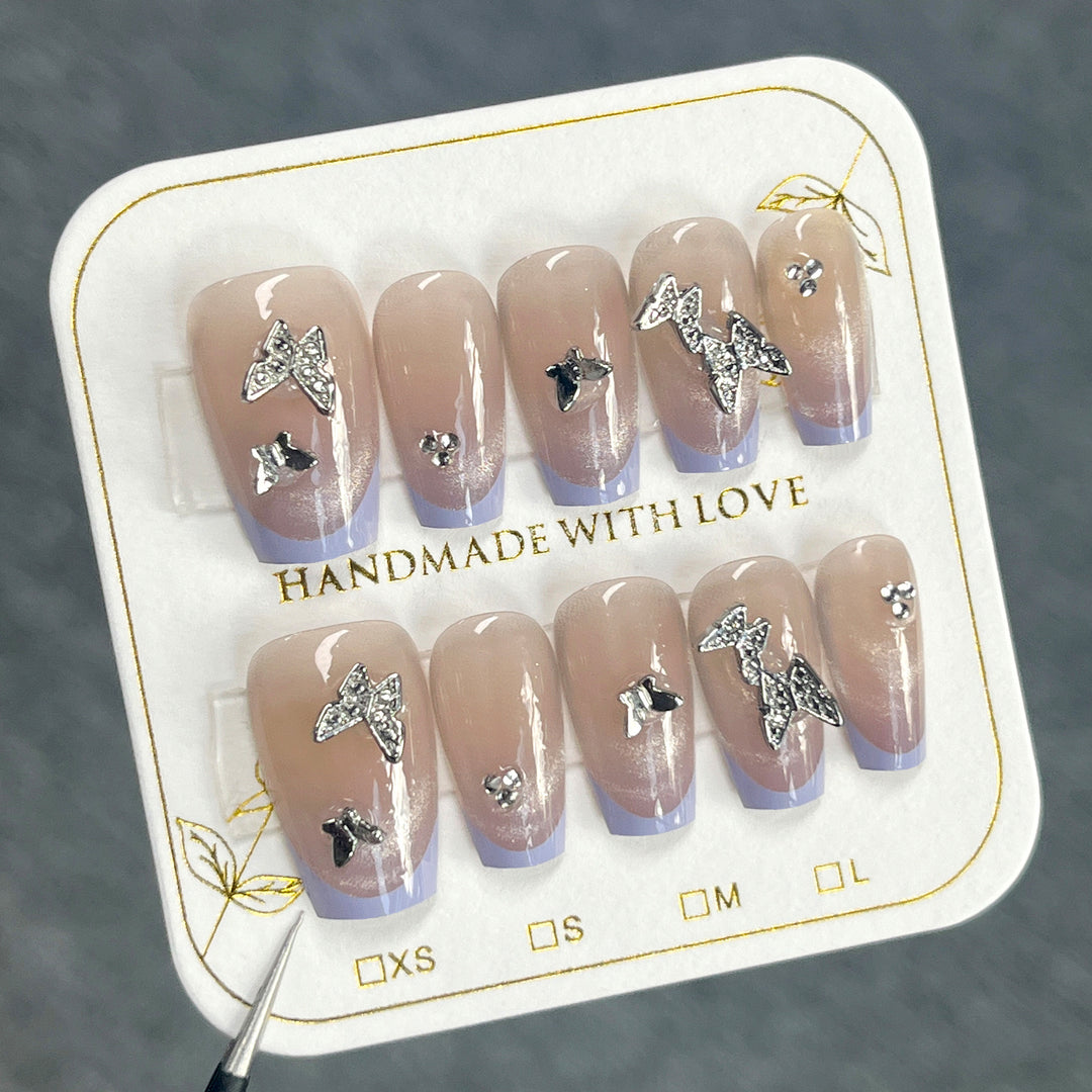 Artificial nail extensions with glitter design and elegant accents Kalsten
