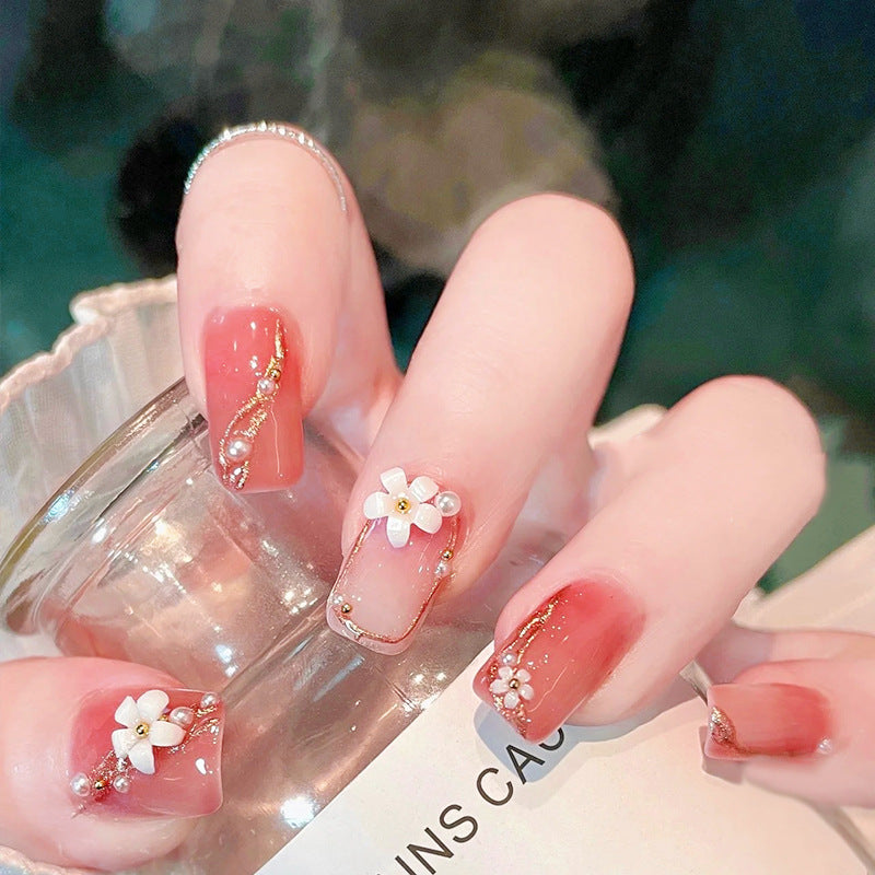 Acrylic nail set with elegant floral decorations and glamorous pearl accents Kalsten