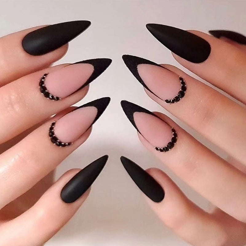 Artful stiletto nails with elegant black design and glitter accents Kalsten