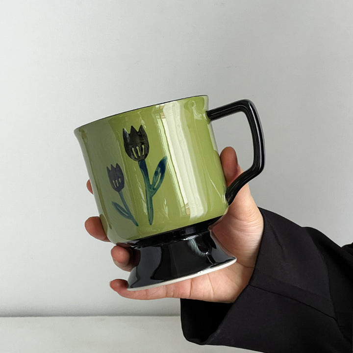 Ceramic cup with foot and hand-painted tulip motif