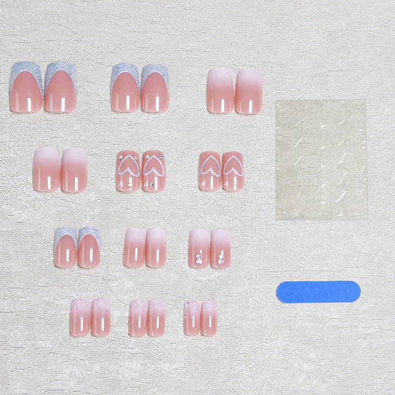 Artificial nails with sparkling heart designs and glitter details Kalsten