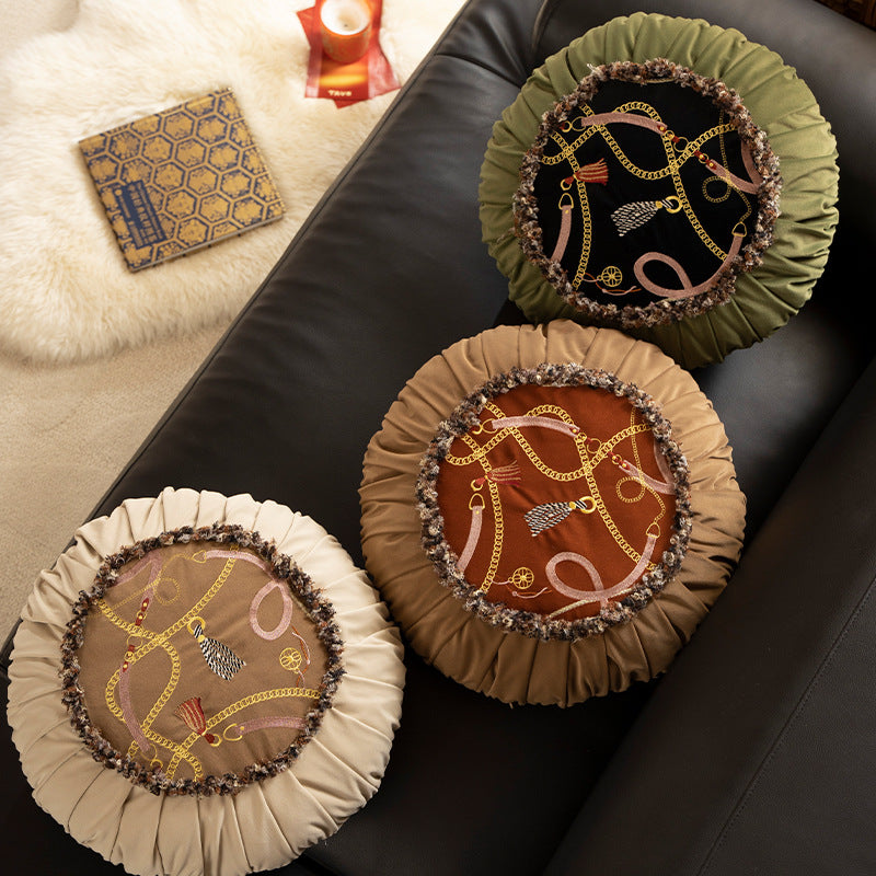 Round decorative pillow with pleated edge, fringe trim, and chain tassel motif Kalsten