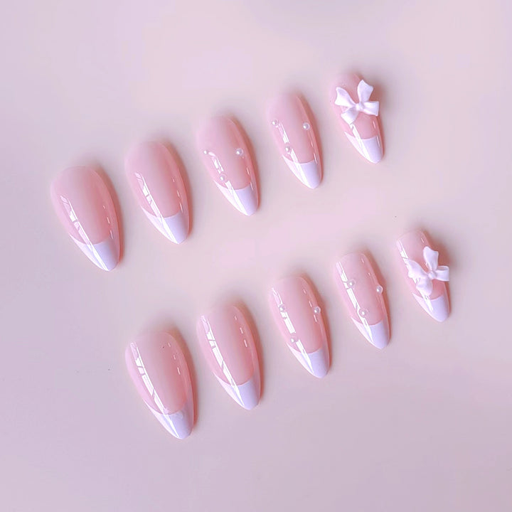 Artificial nail set with shimmering 3D bows and elegant pearl accents Kalsten