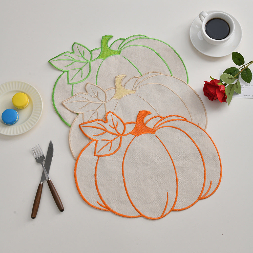 Seasonal table mat placemat made of linen in pumpkin silhouette with colorful embroidered border