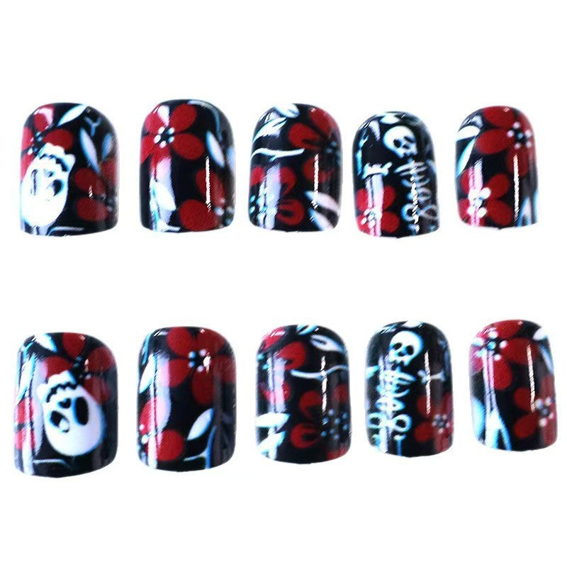 Creative nail art with skull motif and floral elements Kalsten