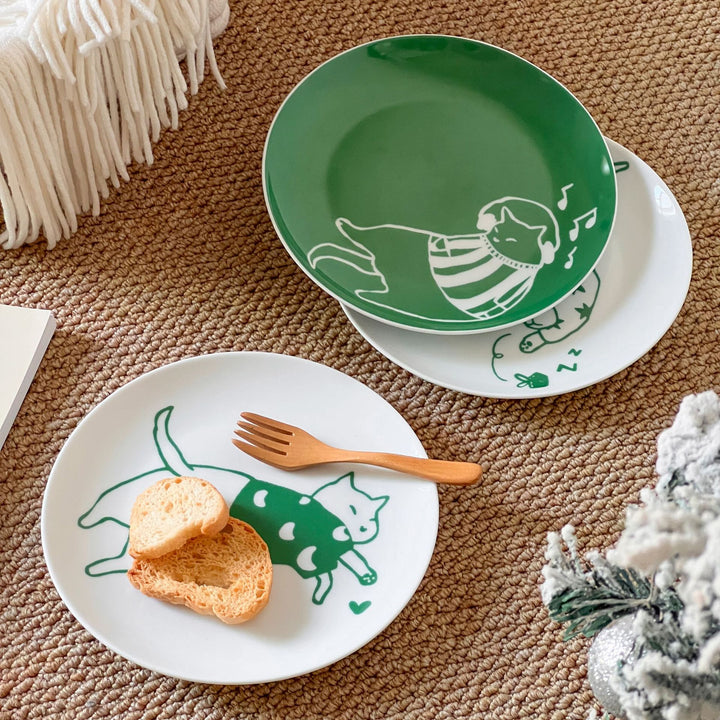 Decorative ceramic plate with cat motif and green border decoration
