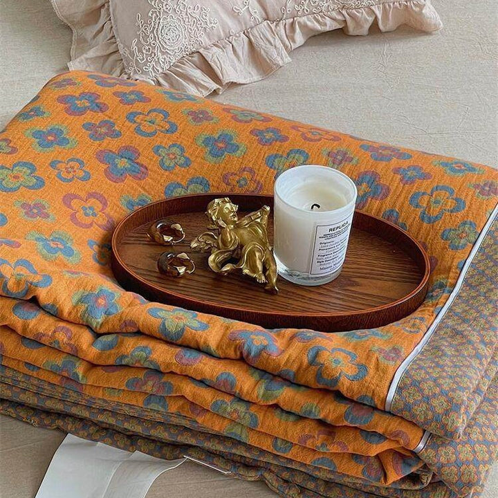 Lightly quilted throw blanket in retro floral jacquard made from cotton-linen mix