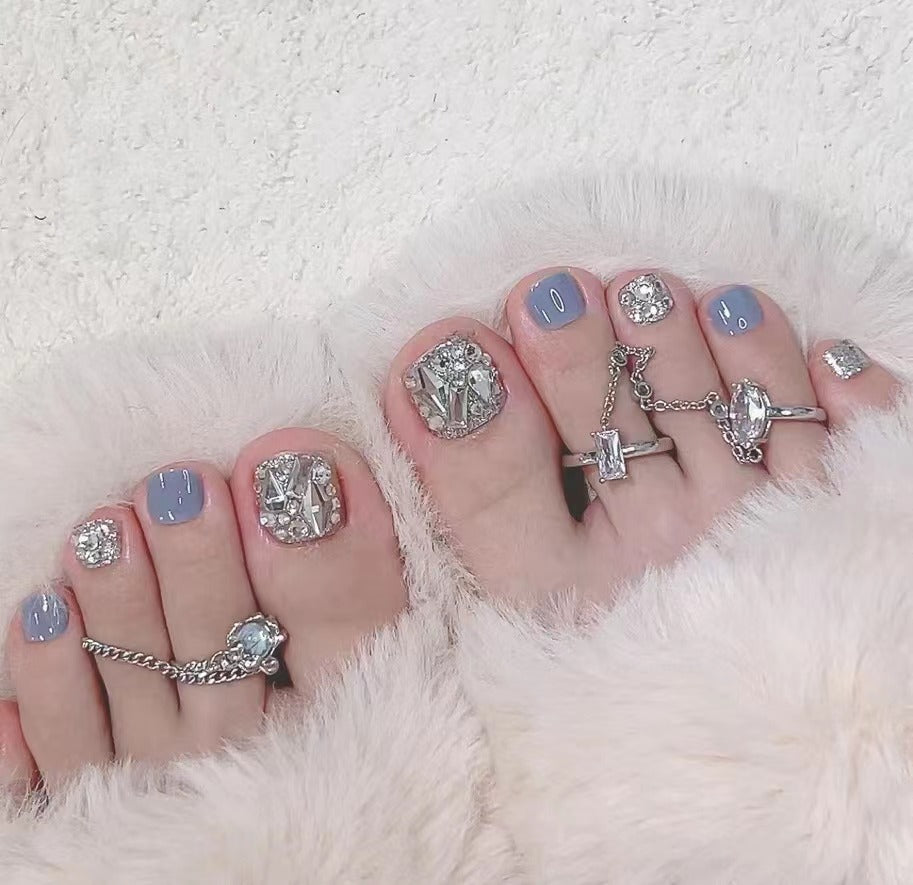 Artistic toenail art with rhinestone and glitter elements Kalsten