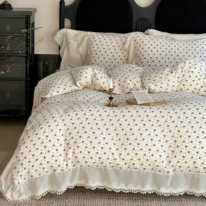 Cotton muslin bedding set with ruffles, lace trim, and delicate bow print