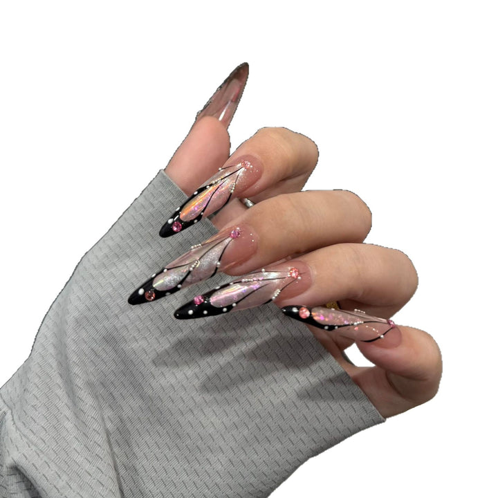 Artifical nail tips with elegant designs and glitter accents Kalsten