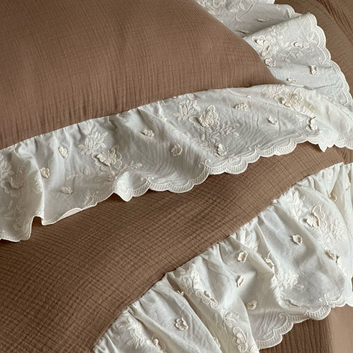 Quilted cotton duvet with embroidered frill and layered ruffled bed skirt