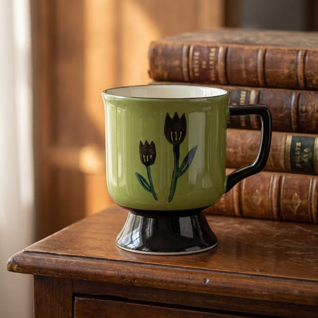 Ceramic cup with foot and hand-painted tulip motif