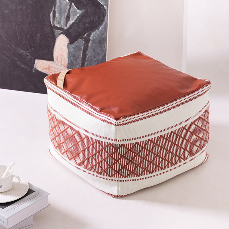 Woven seat pouf with quilted synthetic leather top and carry handle