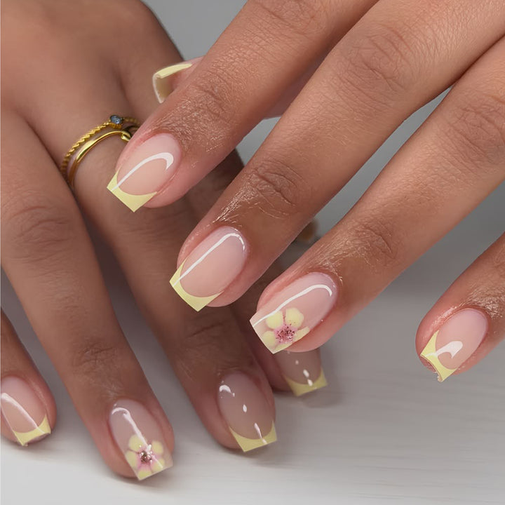 Artistic French-tip nails with floral decorations Kalsten