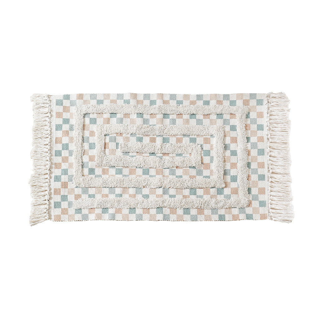 Hand-tufted bathroom mat with fringes, decorative dot-and-dash pattern and non-slip backing Kalsten