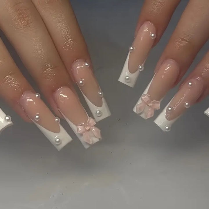 Artistic nail extensions with pearls and bows decorations Kalsten