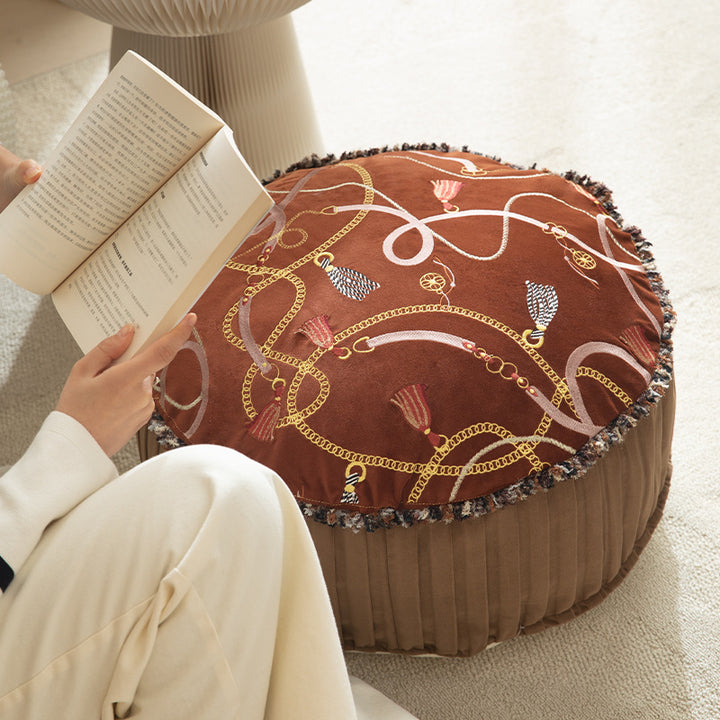 Round decorative floor cushion pouf with velvety printed top, pleated side wall, and fringe edge Kalsten