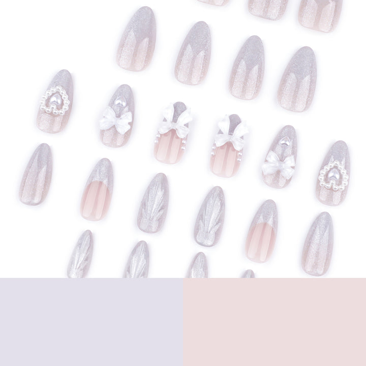 Artful nail decoration with pearl and bow accents Kalsten