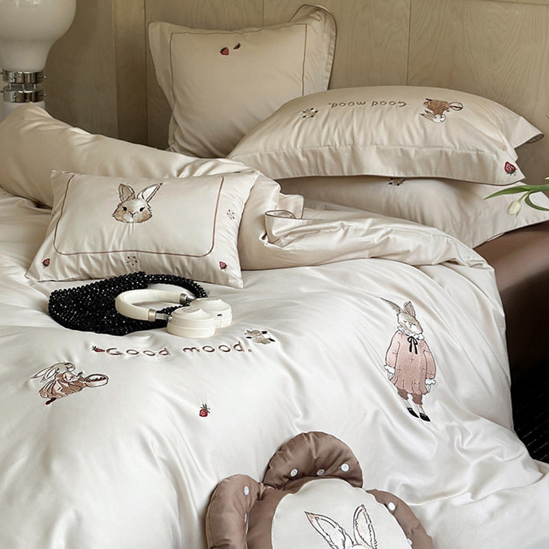 Fine cotton satin bedding set with elaborate bunny embroidery and piped edge