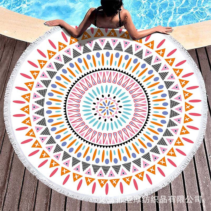 Round beach towel with colorful, tropical floral pattern and fringe decoration Kalsten