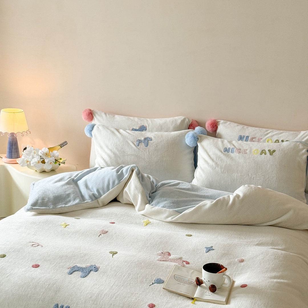 Cozy cotton bedding set with pom-pom appliques and embroidered lettering