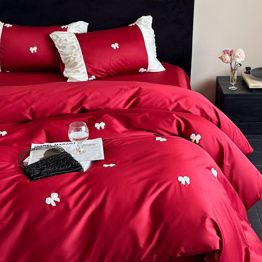 Luxurious cotton satin bedding set with embroidered bows and ruffle details
