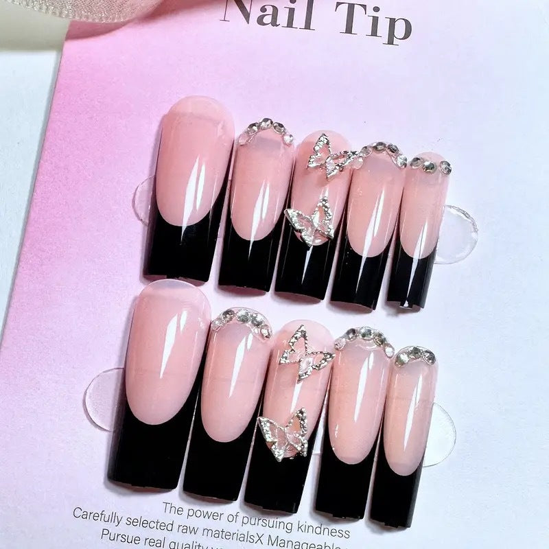 Trendy artificial nails with delicate rhinestone and butterfly accents Kalsten
