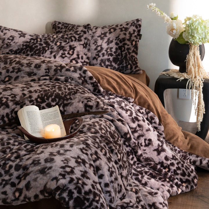 Plush bed cover set with leopard pattern and reversible velvet underside