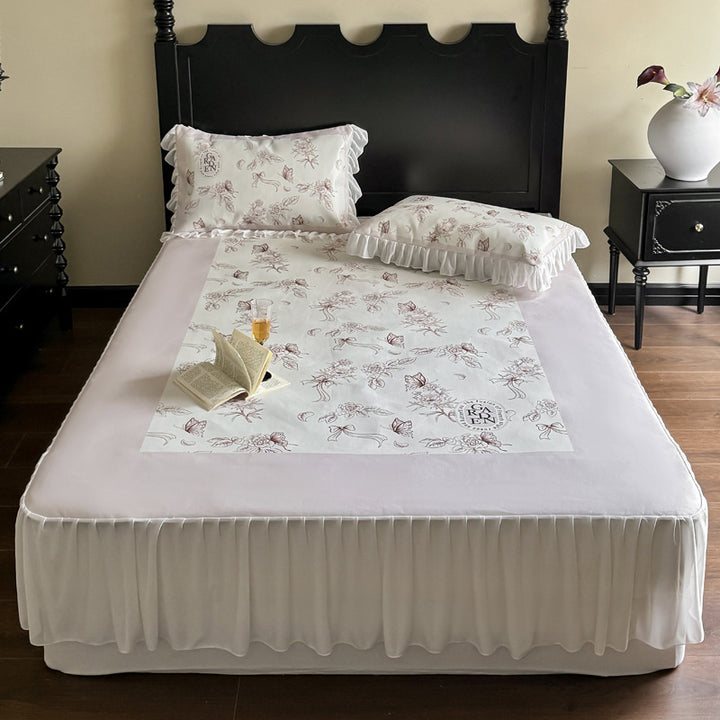 Bedding set with ruffled bed skirt, floral printed center piece and frill pillow