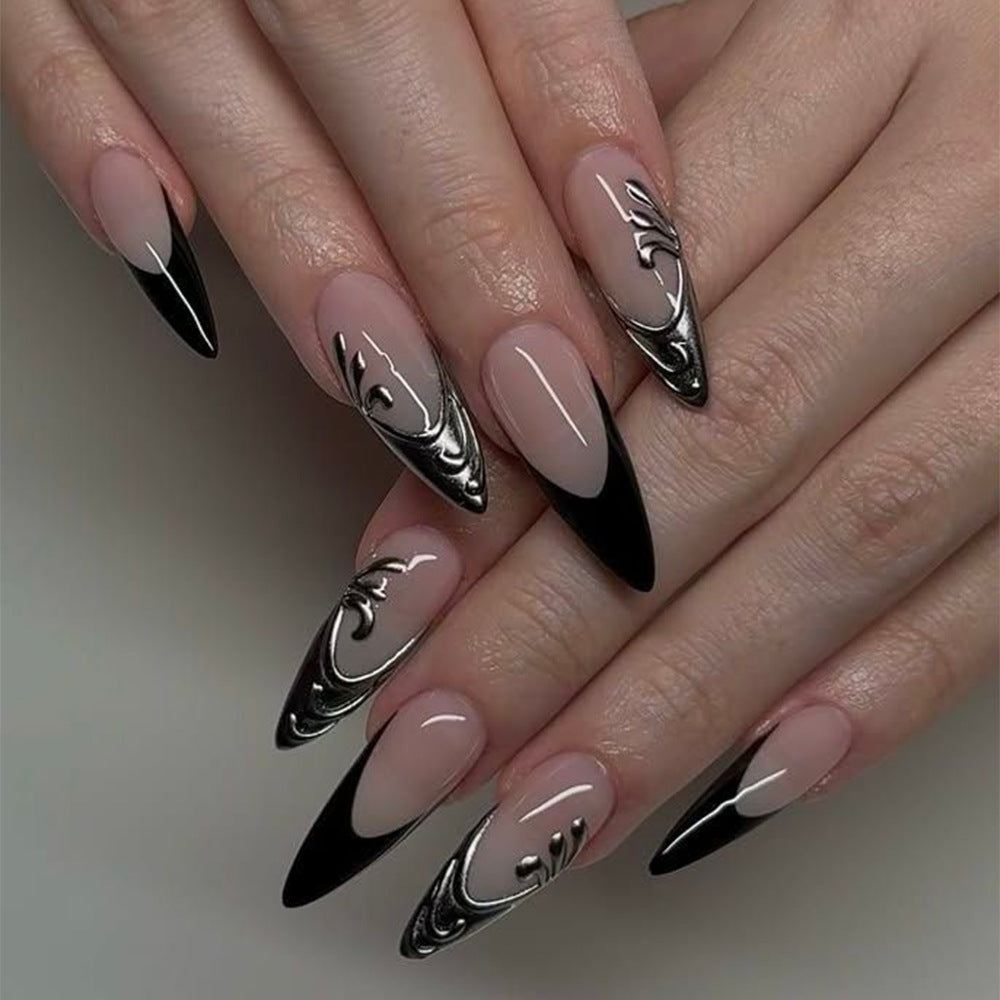 Artificial nails in elegant stiletto style with elaborate metal decoration Kalsten