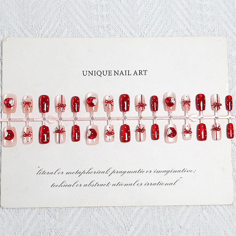 Artificial nail set with festive gift design and elegant glitter accents Kalsten