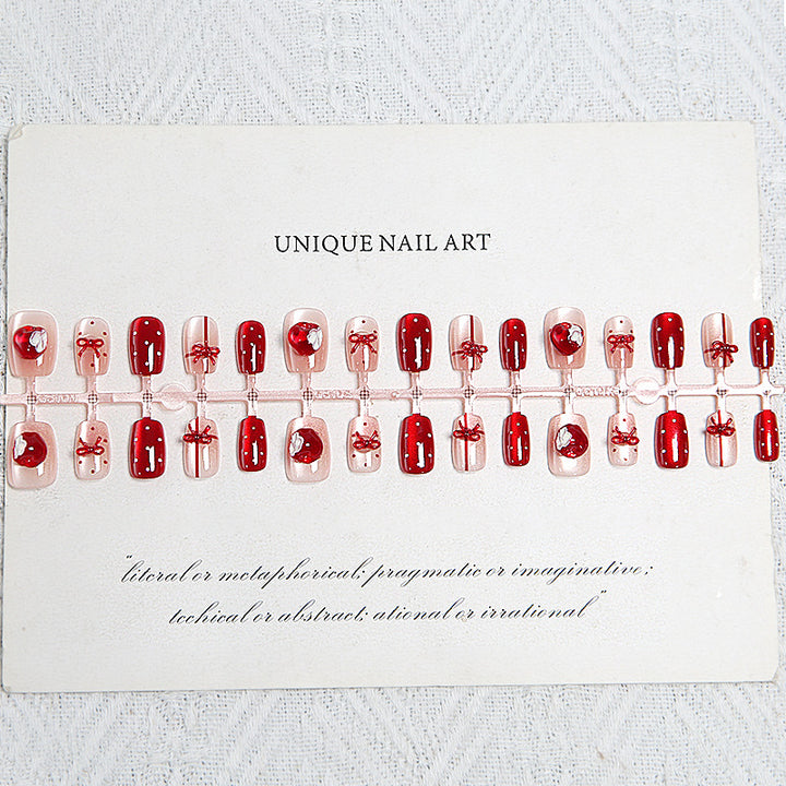 Artificial nail set with festive gift design and elegant glitter accents Kalsten