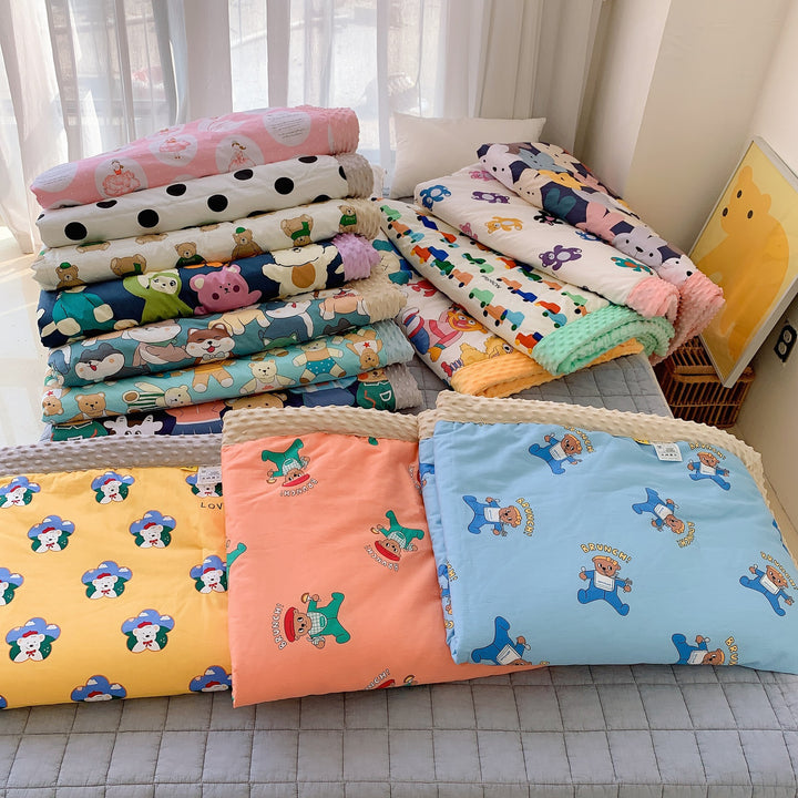 Children's quilt with colorful dinosaur print and soft minky border
