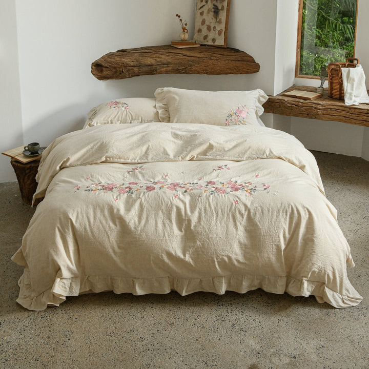 Embroidered linen-look bedding set with ruffle and floral embroidery detail