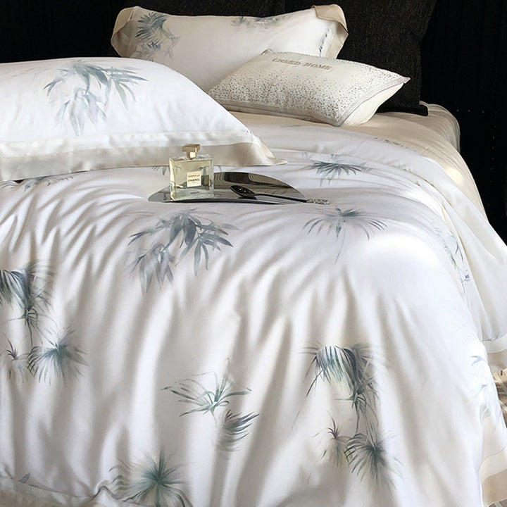 Luxurious cotton satin bedding set with delicate leaf print, contrasting hem and fine piping