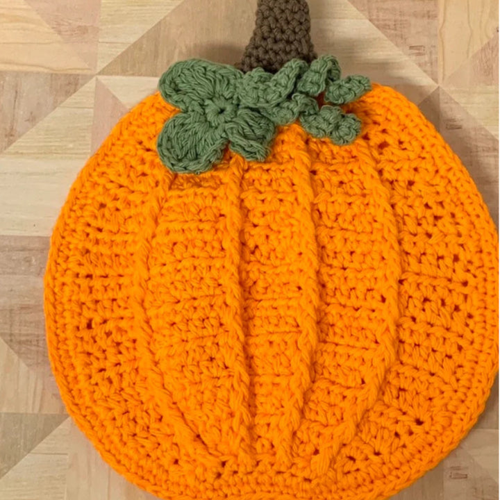 Hand-crocheted pumpkin pot holder and table mat made of cotton yarn