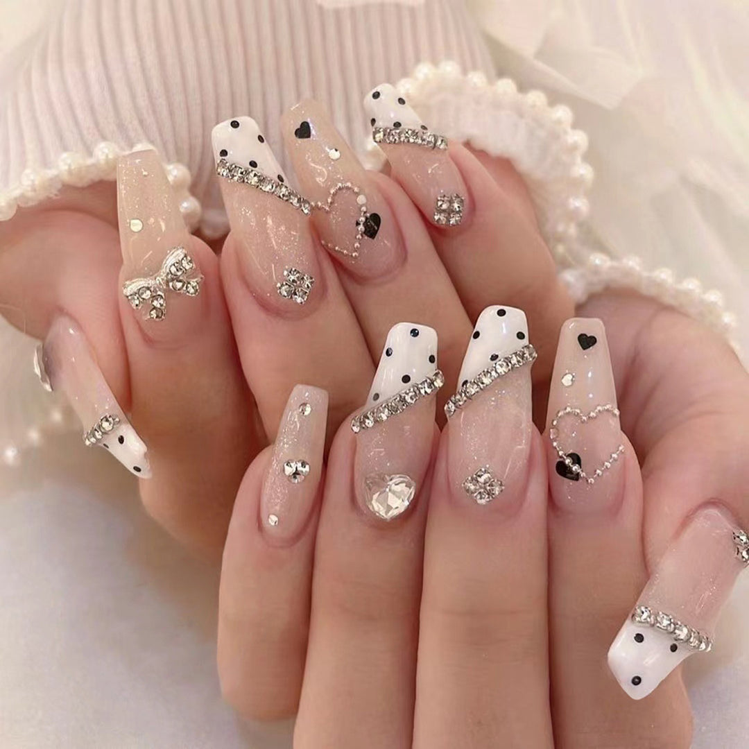 Artful nail extensions with elegant rhinestone and heart designs Kalsten