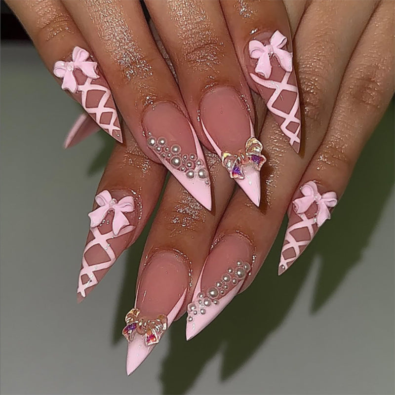 Artful stiletto nails with glitter and bow decoration Kalsten