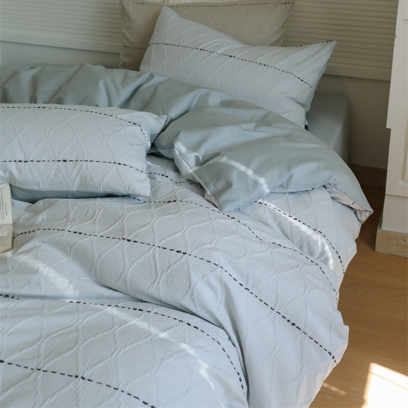 Reversible quilted bedding set made of cotton blend with textured leaf quilting and satin finish back